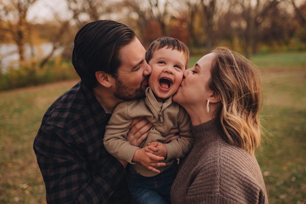 A couple kisses a little boy on either cheek during a photo session in wheaton illinois